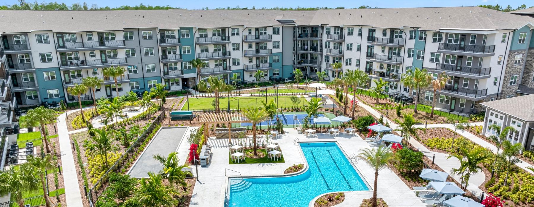 a pool in a courtyard with buildings in the background